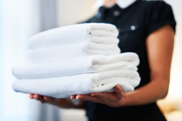 housekeeping amenities with towels Housekeeping employee preps towels for senior resident apartment.