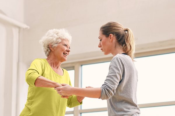 mobility-assistance Senior resident being assisted by caregiver on site.